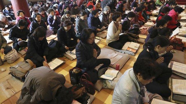 Parents praying in South Korea