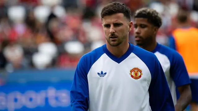 Mason Mount during the warm-up. Andrey Santos is out of focus behind him.