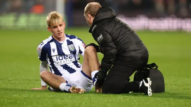 Toby Collyer receiving treatment after being injured in West Brom's Championship match with Birmingham City