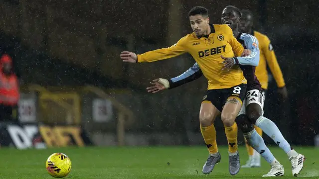 Wolves' Joao Gomes competing with Aston Villa's Amadou Onana