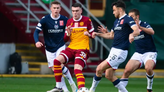 Motherwell's Lennon Miller and Dundee's Finlay Robertson (L) and Scott Fraser (R) in action during a William Hill Premiership match between Motherwell and Dundee at Fir Park, 