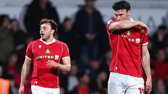 Wrexham duo Ollie Rathbone (left) and Kieffer Moore (right) look dejected