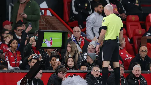 Referee Paul Tierney performs a VAR check