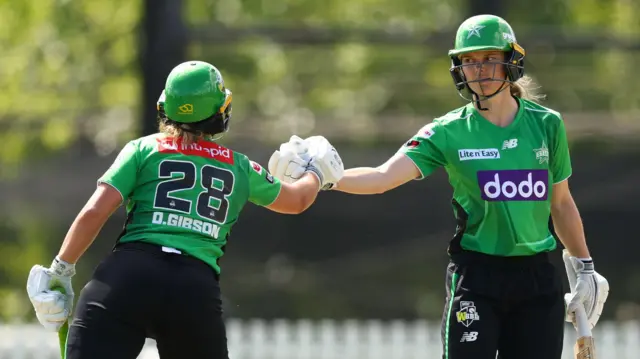 Amy Jones and Dani Gibson punch gloves