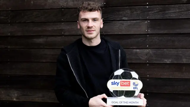 Josh Tymon with the goal of the month trophy