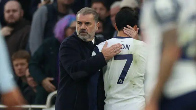 Tottenham Hotspur's Greek-Australian Head Coach Ange Postecoglou (L) consoles Tottenham Hotspur's South Korean striker #07 Son Heung-Min (R) as he is substituted during the English Premier League football match between Tottenham Hotspur and Aston Villa at the Tottenham Hotspur Stadium