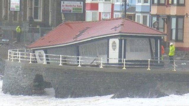 A seaside shelter falling into the sea