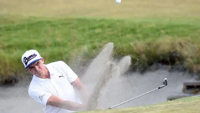 Rickie Fowler hits a bunker shot