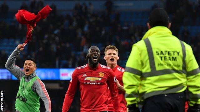 Manchester United's players celebrate at the final whistle after coming from 2-0 down to beat Manchester City