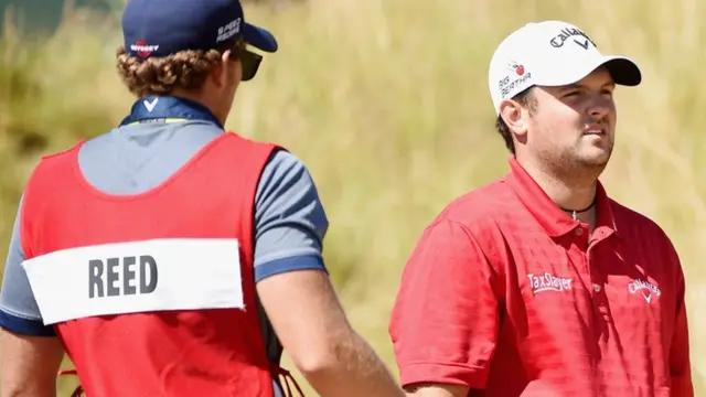 Patrick Reed stands with his caddie