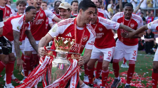 Arsenal Manager Mikel Arteta celebrates with the Premier League trophy 