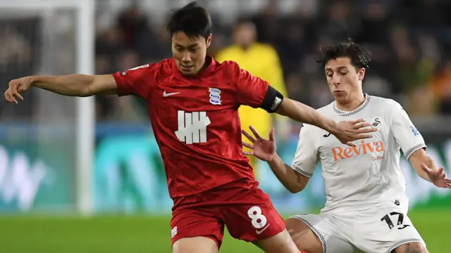 Goncalo Franco of Swansea City is challenged by Paik Seung-Ho of Birmingham 