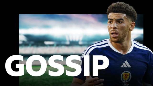 Che Adams, wearing Scotland's dark blue home shirt with white Adidas stripes on the shoulder and a white adidas logo in the centre with the Scotland badge below. Adams appears on top of BBC Sport's gossip column graphic which has 'gossip' written in white letters on top of a blurred out floodlit football stadium.