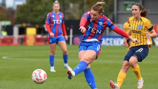 Felicity Gibbons of Crystal Palace shoots whilst under pressure from Bruna Vilamala of Brighton & Hove Albion during the Barclays Women's Super League match between Crystal Palace v Brighton & Hove Albion