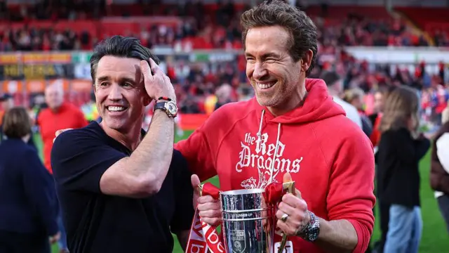 Rob McElhenney and Ryan Reynolds with the League One promotion trophy 