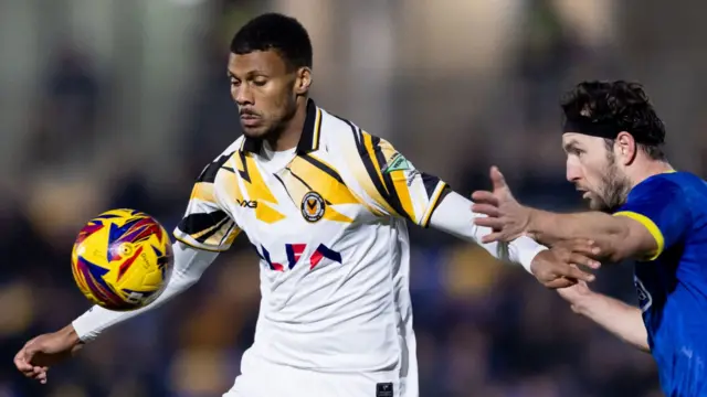 Newport County's Kyle Jameson receives the ball under pressure from a defender