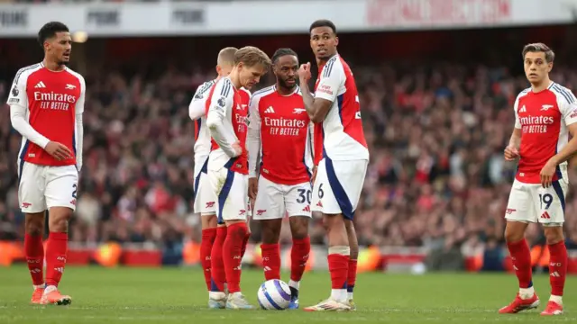 Raheem Sterling of Arsenal prepares to take a free-kick as his teammates look on during the Premier League match between Arsenal FC and West Ham United FC