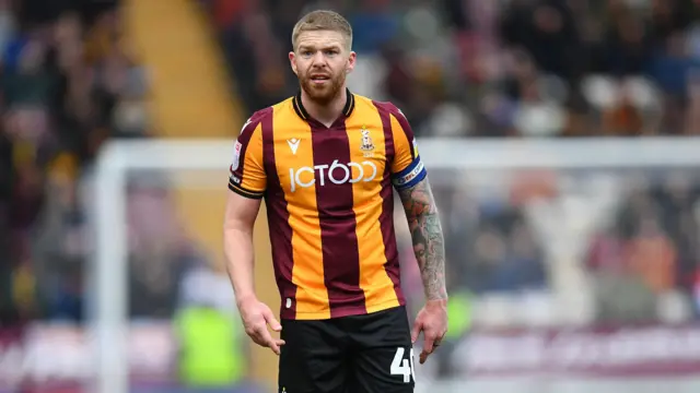 Adam Clayton captaining Bradford City towards the end of his playing career in 2023.