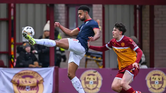 Eli Campbell and Tom Sparrow go for the ball