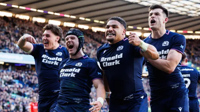 Scotland players celebrate after scoring a try