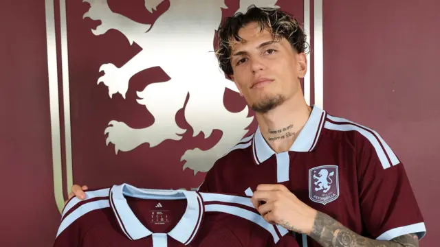 Alejandro Garnacho holding his  of Aston Villa