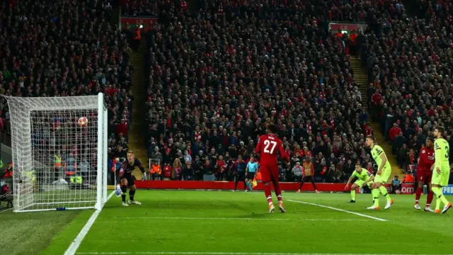 Divock Origi scores against Barcelona at Anfield. The image shows the ball entering the goal.