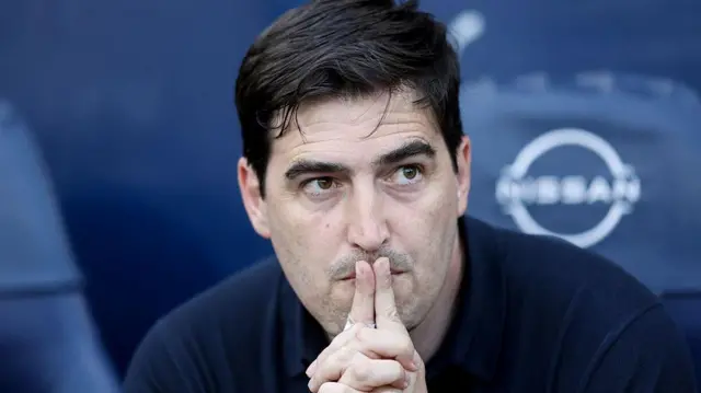 Andoni Iraola looks on thoughtfully from the dugout