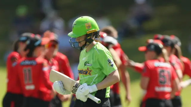 Melbourne Renegades celebrate as Tahlia Wilson leaves field after being dismissed