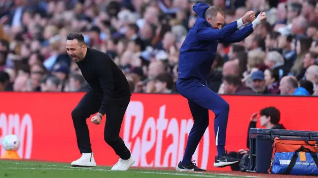 Roberto De Zerbi and assistant Andreas Georgson celebrate