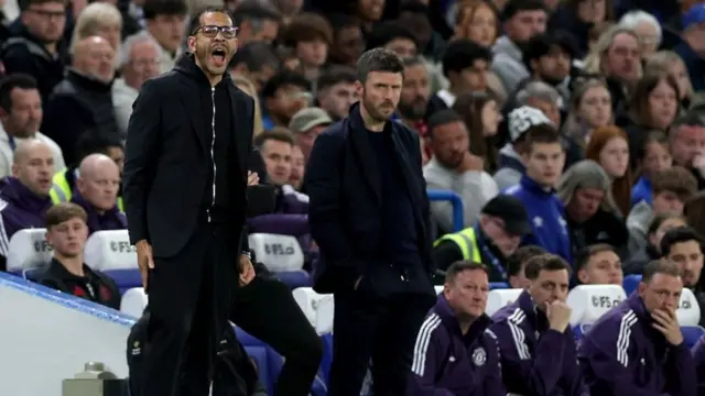 Liam Rosenior and Michael Carrick on the touchline during the Chelsea v Manchester United game earlier in April