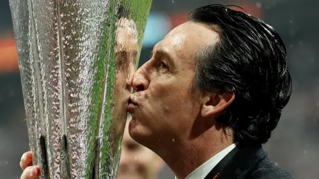 Aston Villa manager Unai Emery kisses the trophy as he celebrates after winning the Europa League