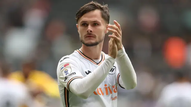 Liam Cullen of Swansea City applauds fans