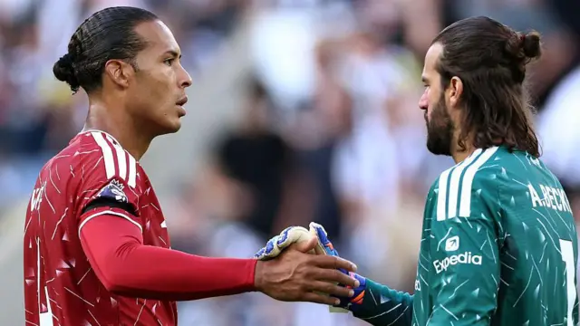Virgil van Dijk embraces Alisson