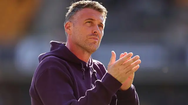 Rob Edwards, Manager of Wolverhampton Wanderers, applauds the fans 