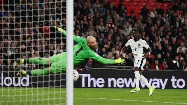 England's Bukayo Saka scores his team's first goal past Serbia's Predrag Rajkovic