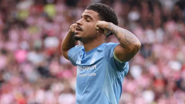 Nottingham Forest captain Morgan Gibbs-White celebrating by putting his fingers in his ears