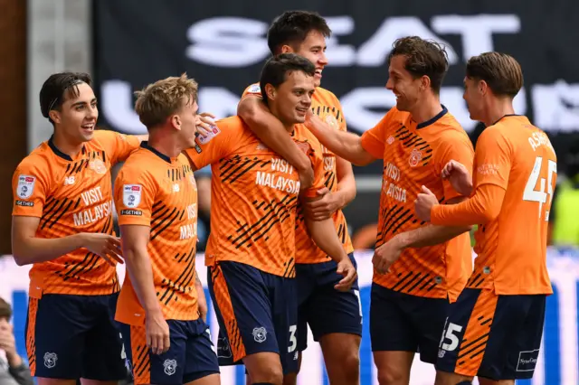 Perry Ng celebrates a goal at Wigan with Cardiff team-mates 
