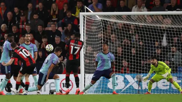 Ryan Christie finishes a corner routine, curling his shot through a sea of bodies and into the back of the Arsenal net