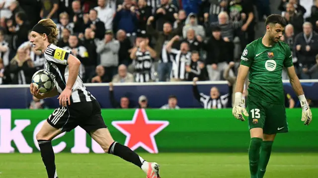 Anthony Gordon celebrates after scoring against Barcelona