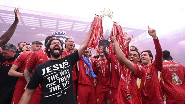 Liverpool players lift the Premier League trophy at Anfield