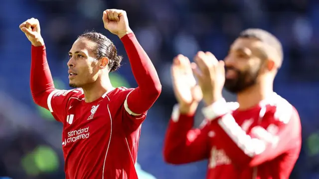 Liverpool's Van Dijk and Salah celebrate a win at Everton