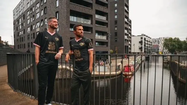 Palermo players wearing new away kit in front of docks in Manchester