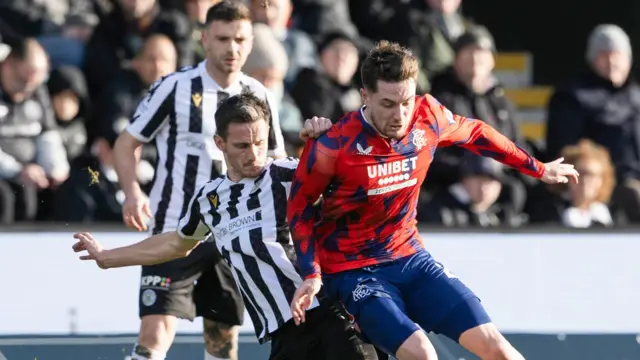 St Mirren's Scott Tanser tackles Rangers' Scott Wright