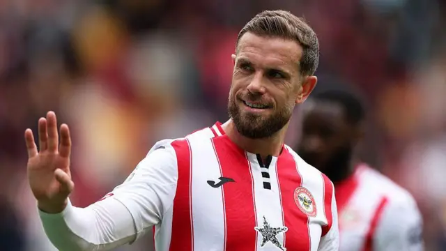 Jordan Henderson waves to the Brentford fans