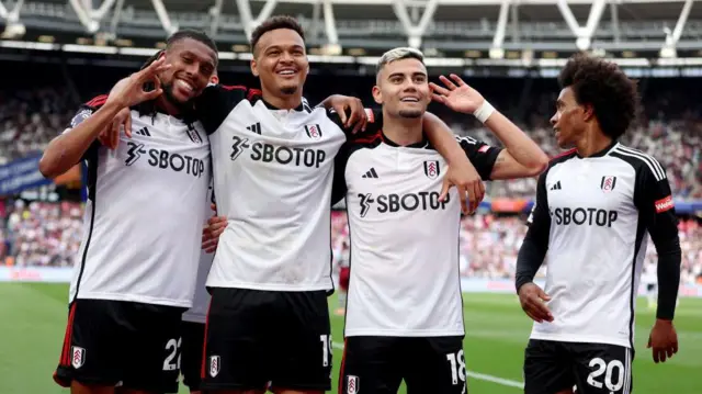  Andreas Pereira celebrates scoring his team's second goal with Alex Iwobi, Rodrigo Muniz and Willian