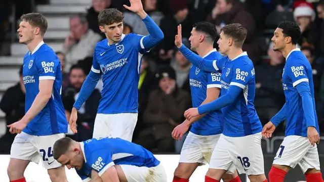 Callum Lang celebrates scoring against Derby with his Portsmouth team-mates