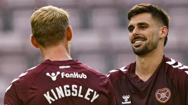 Heart of Midlothian's Claudio Braga (R) and Stephen Kingsley celebrate their side's 4-1 victory during a Premier Sports Cup group stage match between Heart of Midlothian and Dunfermline at Tynecastle Park