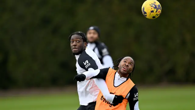 Axel Disasi and Raheem Sterling compete for the ball in training