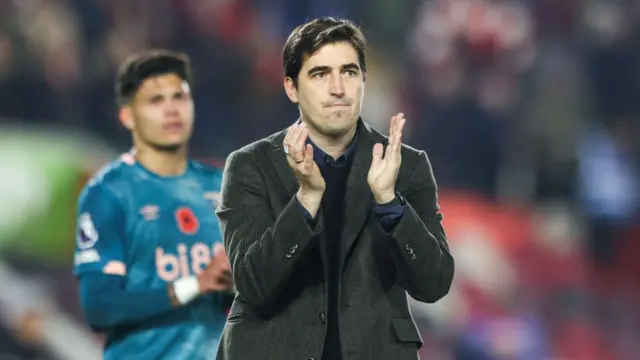 Andoni Iraola, manager of Bournemouth, applauds the traveling support 