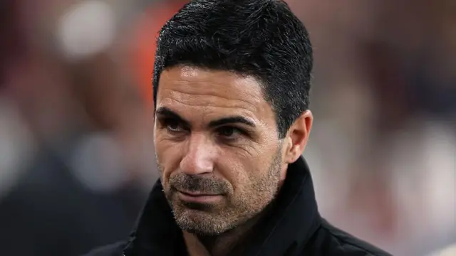 A close up of Mikel Arteta looking thoughtful